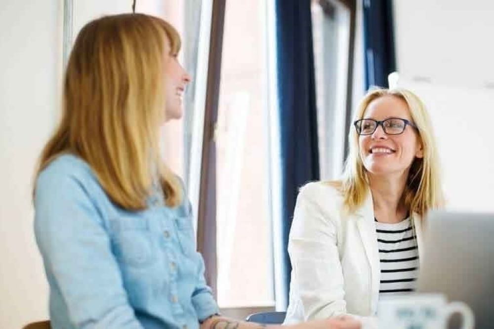 businesswomen discussing in office low 1000 667