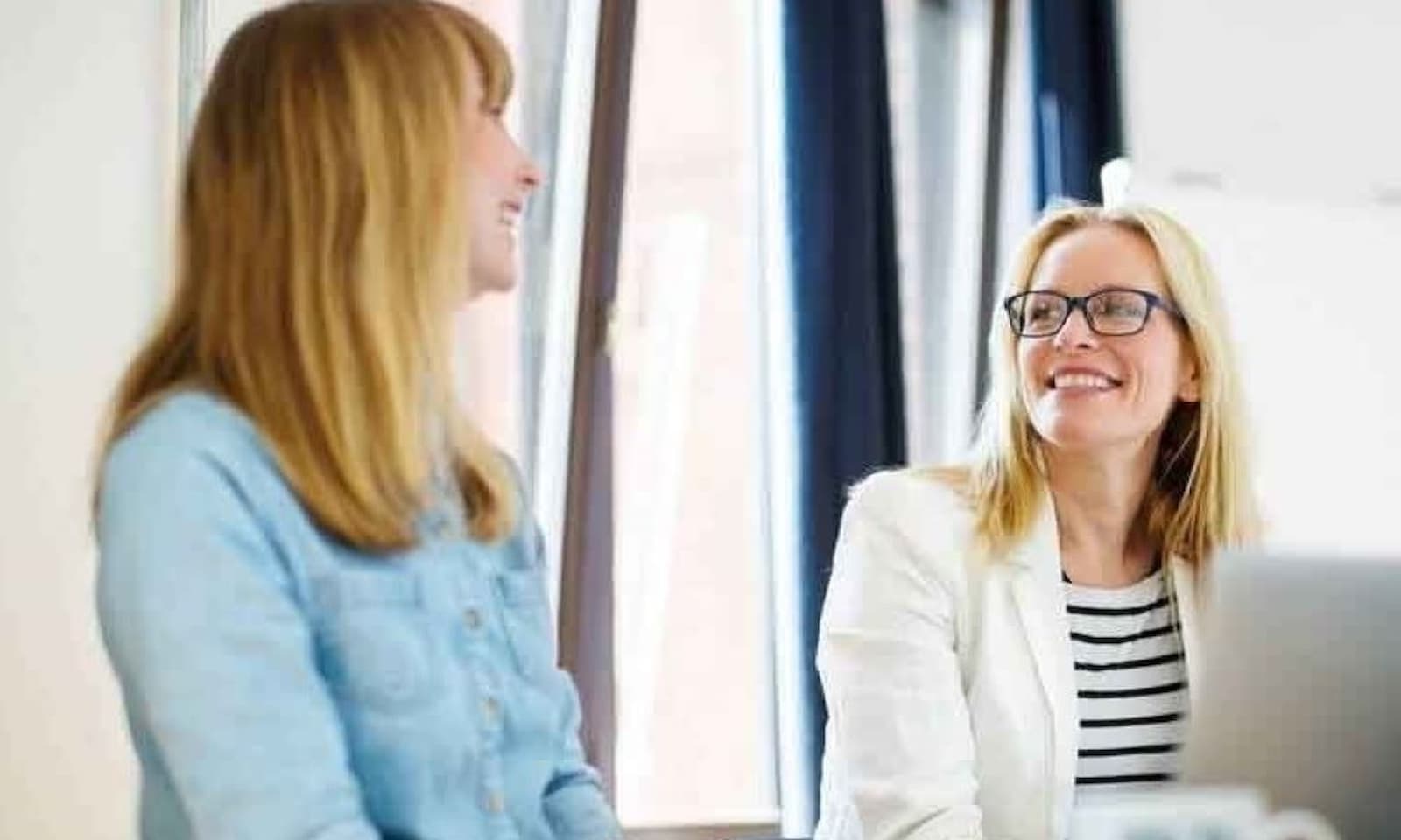 businesswomen discussing in office low 1000 667